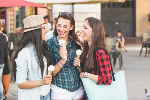 depositphotos 73874065 stock photo three happy women eating ice
