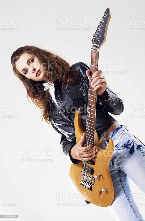 Portrait of a beautiful stylish woman with electric guitar